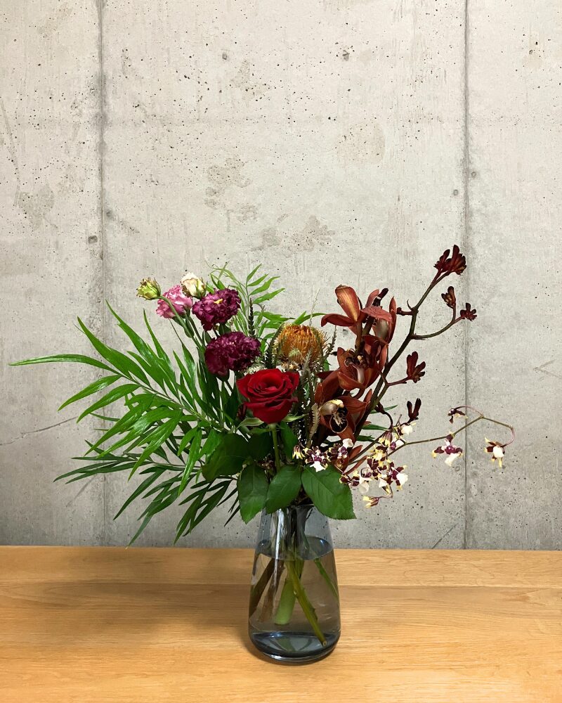 medeluのMODERNコースボリュームBasicのお花を青の透明ガラス花瓶に生けた様子