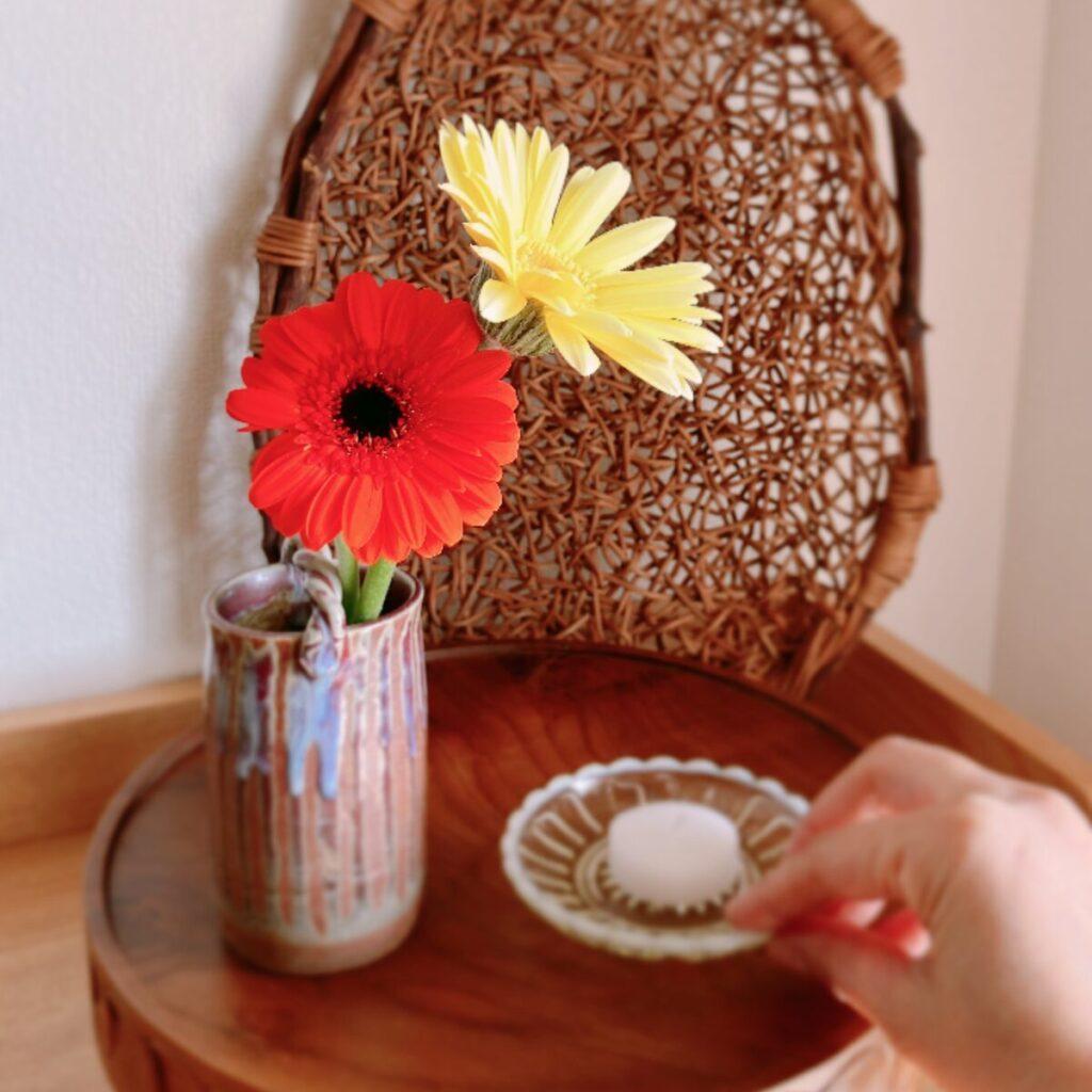 A variation of the first scene, swapping the incense for a candle on a glass plate