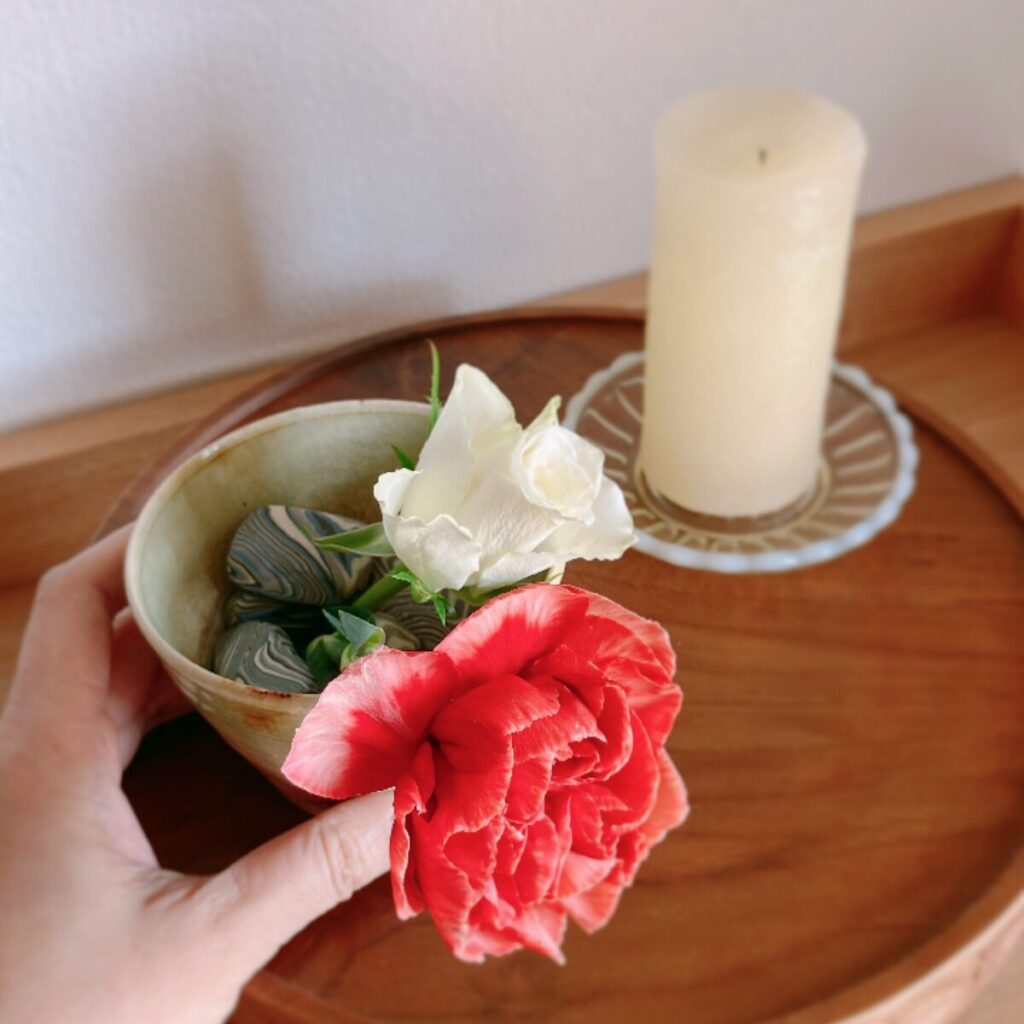 Close-up of stones inside a cup used to stabilize carnations, showing a floral hack