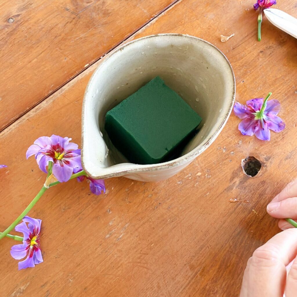 A Japanese ceramic sauce pitcher (Katakuchi) prepared with green floral foam inside