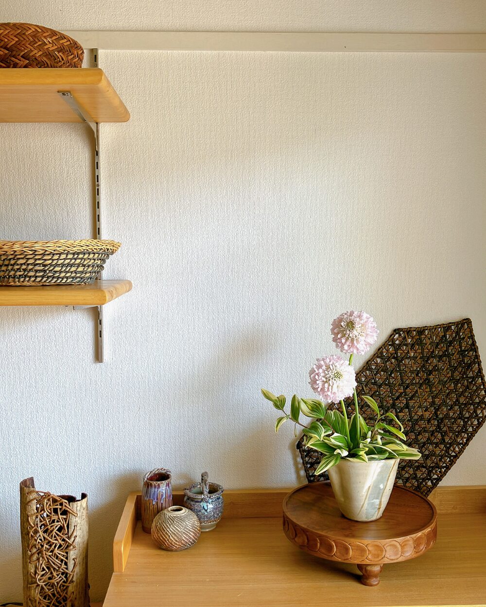 Japandi interior scene with a Scabiosa flower arrangement on a wooden surface