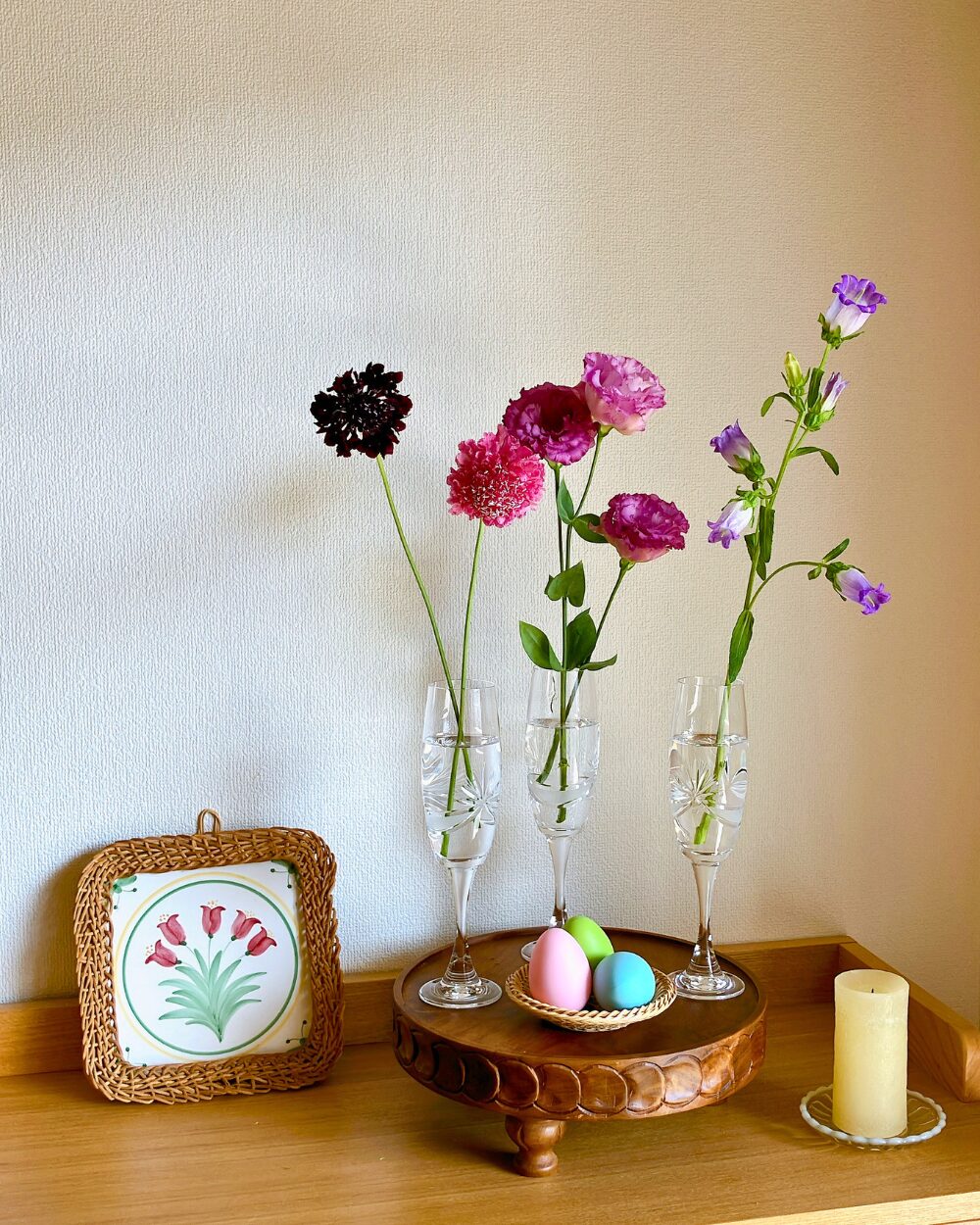 Chic Easter arrangement with purple Lisianthus and Scabiosa in glass vessels