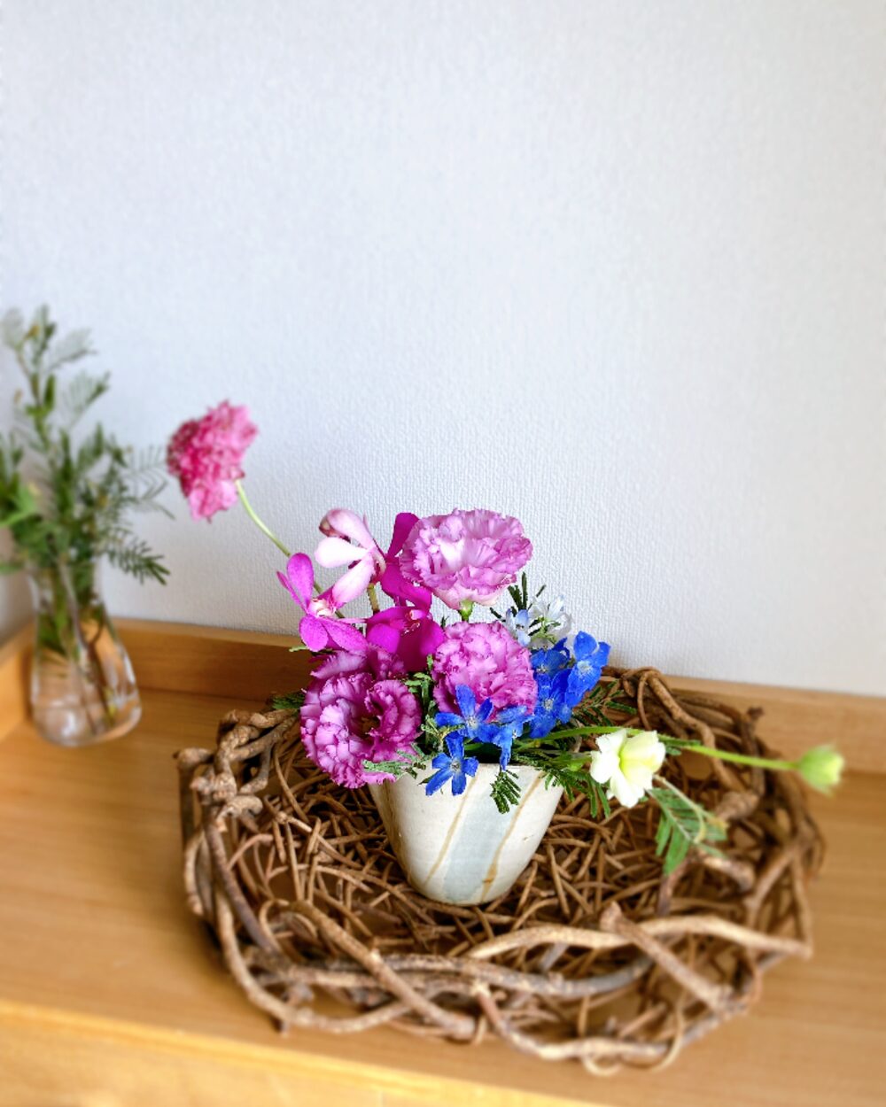 Close-up of a sophisticated arrangement featuring deep purple Lisianthus and blue flowers