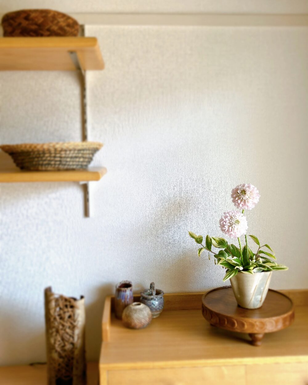 Japandi interior scene with a Scabiosa flower arrangement on a wooden surface