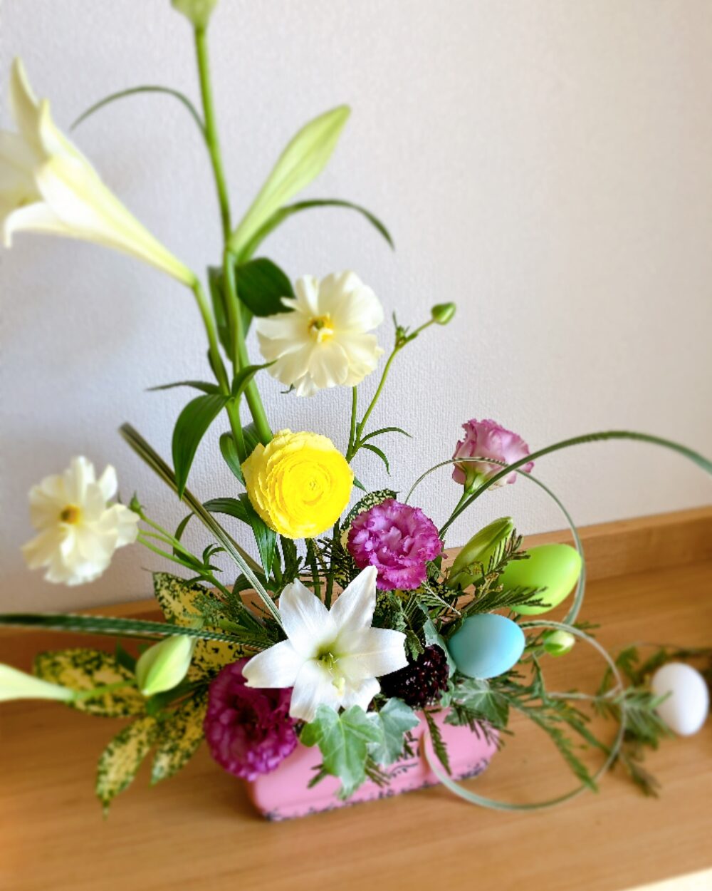 Easter setting with a grand floral arrangement, Western tiles, and scattered eggs