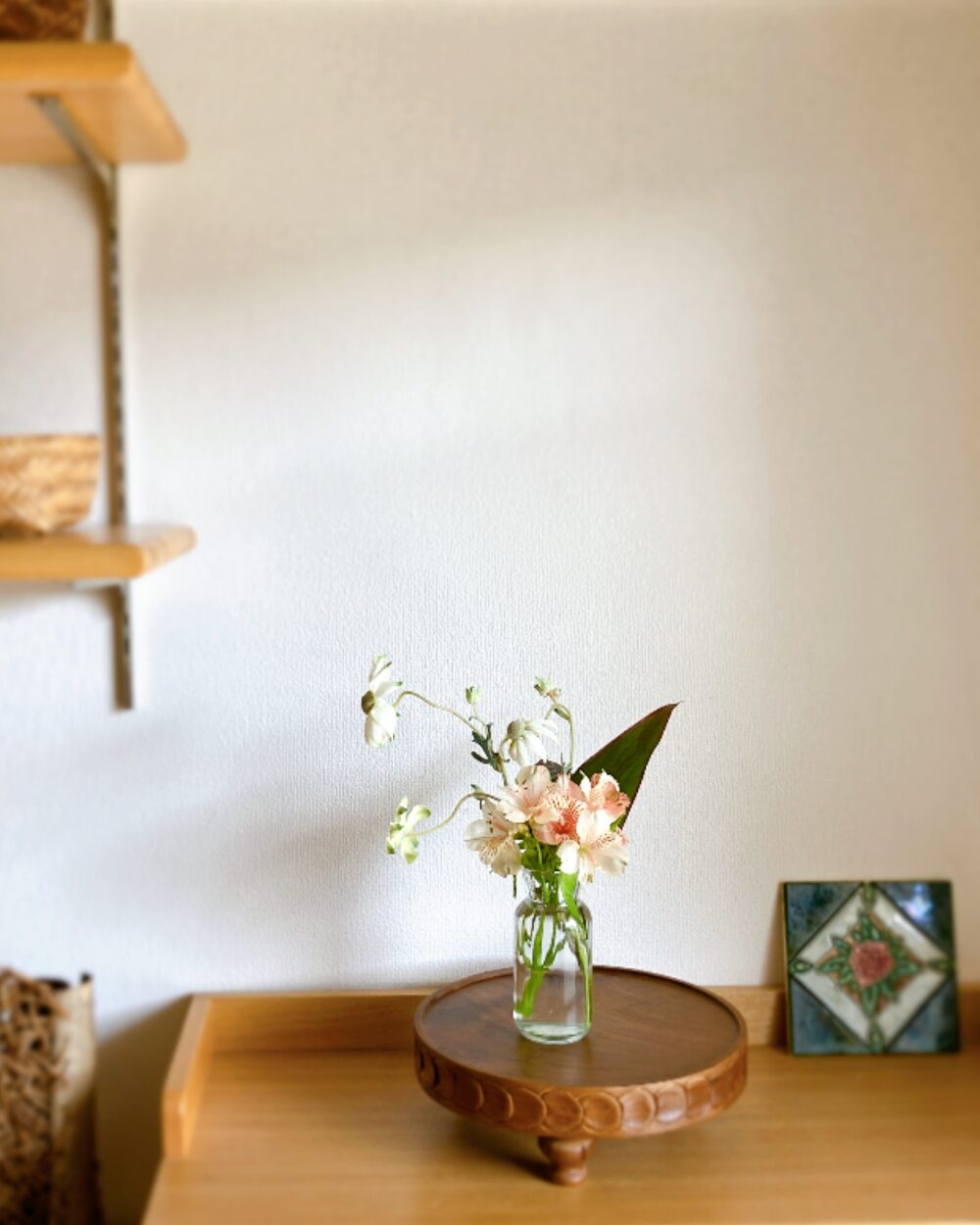 A final pull-back shot of the floral styling session, capturing a serene Zen atmosphere with seasonal greenery