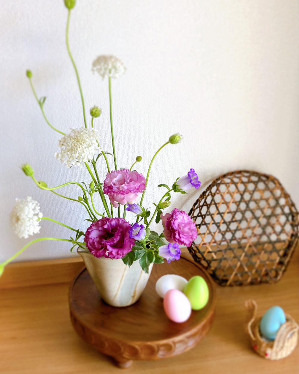 oba-tsuyu pitcher used as a vase for a spring flower arrangement with a wicker basket
