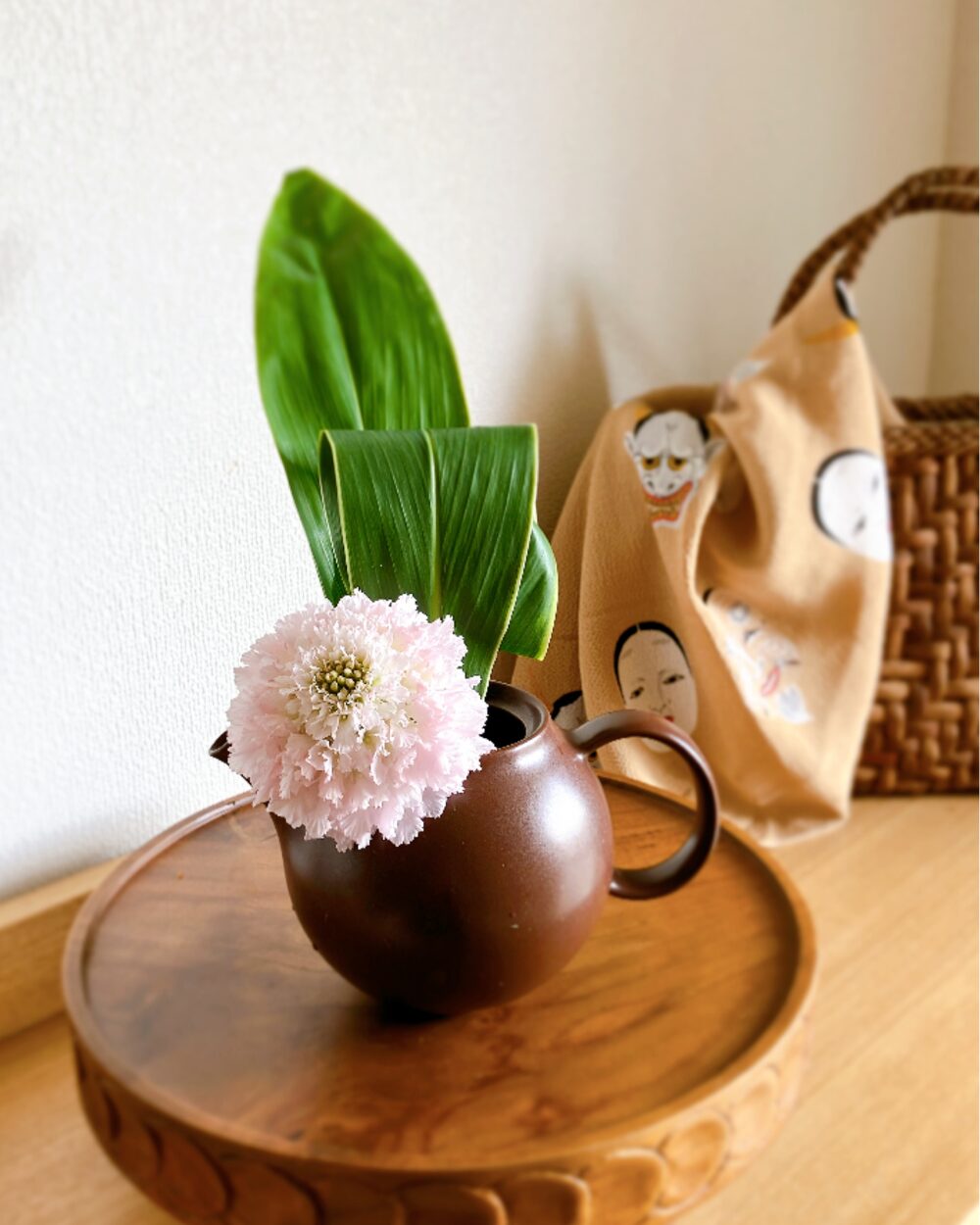 Scabiosa in a Japanese teapot with an eccentric face-patterned Furoshiki