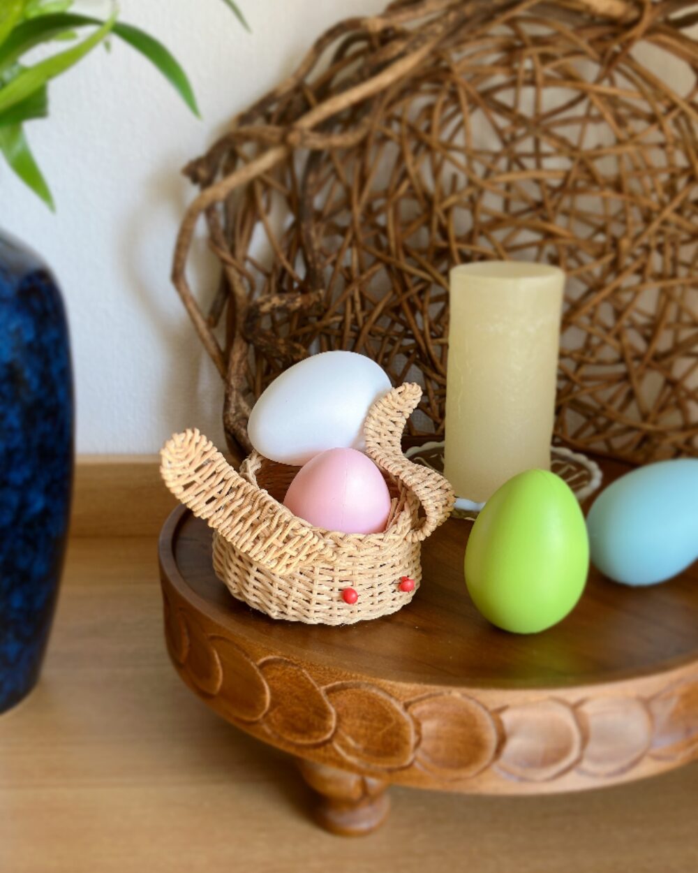 Detail of a hand-woven wicker rabbit basket filled with simple Easter eggs
