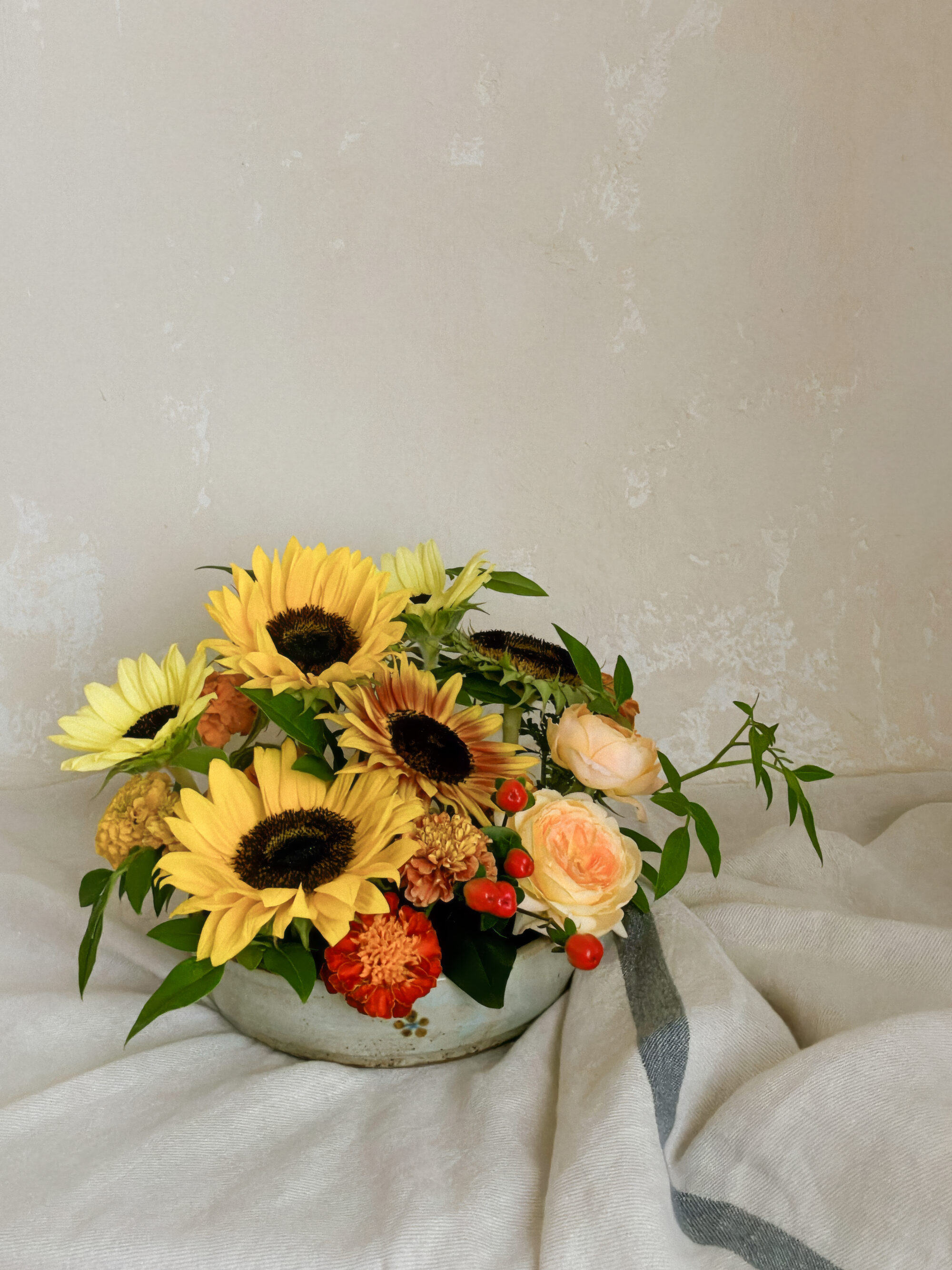A fine-art photo preview of the abundant low sunflower and marigold dish captured dramatically against a dark background.