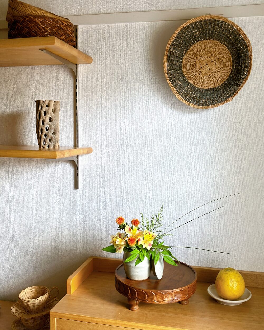 A compact ceramic jar arrangement on a minimalist interior shelf.