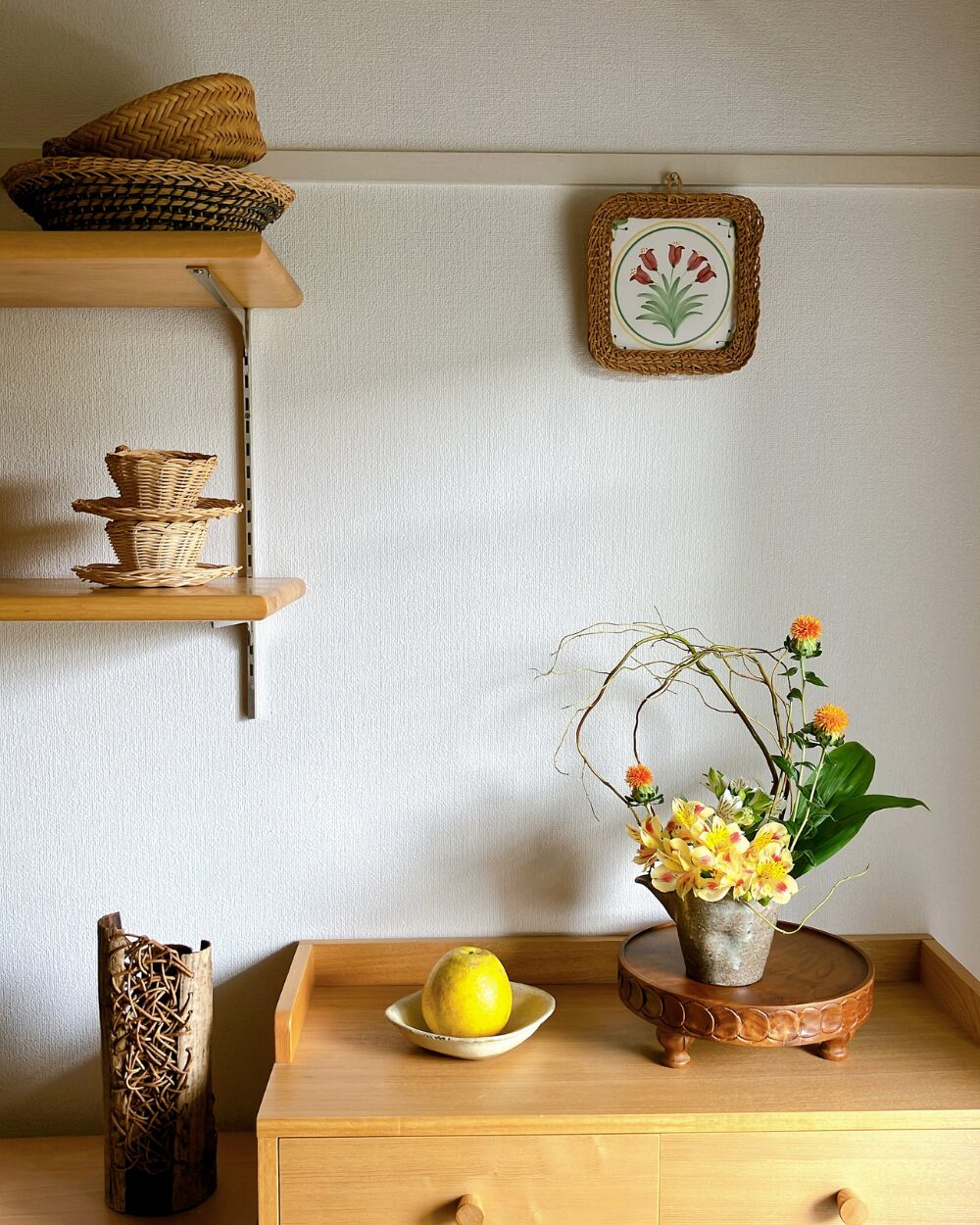 A styled shelf corner featuring a Japanese ceramic bowl arrangement.